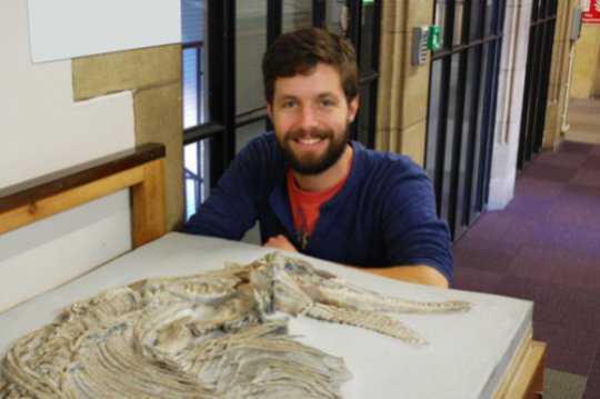 Jonathan Hanson with the ichthyosaur skeleton at the School of Earth Sciences. Credit: Image courtesy of University of Bristol